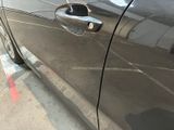 a close up of a car ' s door handle with a sticker on it