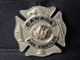 a badge on the hat of a fire fighter