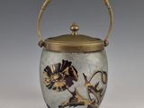 a vase with a handle that has a design on it