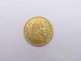 a close up of a gold coin on a white surface