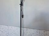a lamp that is on a stand in the corner of a room