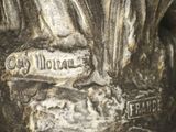 a close up of a statue of a man with a sword