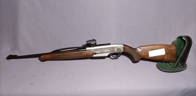 an old gun with a wooden barrel and a leather case
