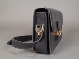 an image of a black purse on a table