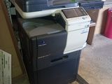 a printer sitting on top of a stack of boxes
