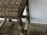a small wicker stool sitting on the floor