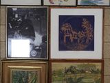 many framed pictures hanging on the wall of a room