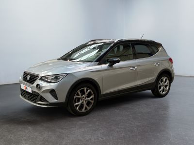 a silver car parked in a room with a white wall