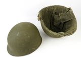 an old helmet and a small bag on a white surface