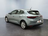 the rear view of a grey car in a showroom