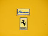 a picture of a ferrari emblem on a yellow wall