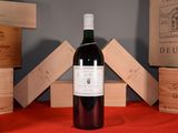 a bottle of wine sitting on a table next to wooden boxes