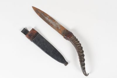 an old knife and a knife blade on a white surface