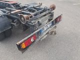 a truck with a trailer attached to it in a parking lot
