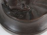 a bronze statue of a man on a horse on a pedestal