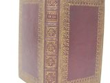 an old book sitting on top of a table next to a white background