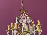 an old chandelier hanging from the ceiling in a purple room