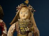 two figurines that are standing next to each other
