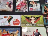 a lot of coca cola advertising signs on the table