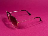 sunglasses on a pink surface with a pink background
