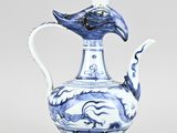 blue and white porcelain teapot with a bird on top of it