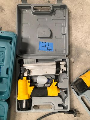 a box with a hammer and a nail gun in it