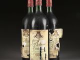 three bottles of wine are sitting on a table in front of a black background