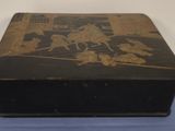 a black box sitting on top of a blue cloth