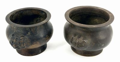 two vases sitting next to each other on a white surface