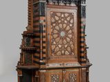 a wooden clock that is on display on a table