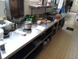 a kitchen with a lot of pots and pans on the counter