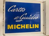 blue and yellow sign on a white wall with a measuring tape