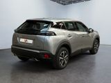 the rear view of a silver suv parked in a showroom