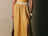 a woman in a yellow dress posing for a picture
