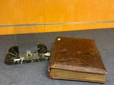 an old book and a lighter on a table