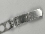 a silver watch that is laying on a white surface