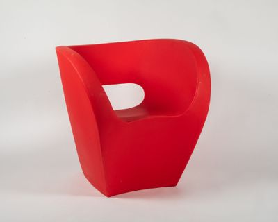 a red chair with a hole in the middle of it