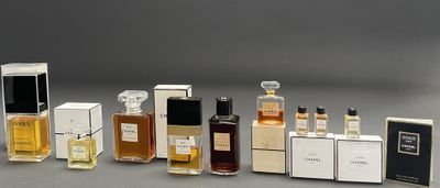 several different types of perfume bottles lined up on a gray surface