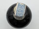 a close up of a bottle with a stamp on it