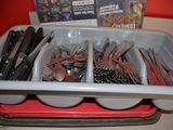 spoons, forks, and spoons in a plastic container on a table