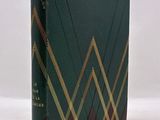 a book with a green cover and gold lines on it