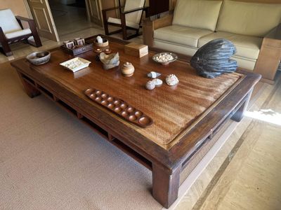 a wooden coffee table with a lot of objects on it