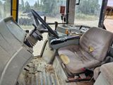a view of the inside of a construction vehicle from the driver ' s seat