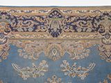 a blue rug with a floral design on it