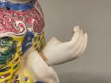 a figurine of a woman with a hat on her head