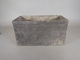 a small metal planter that is sitting on a table