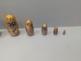 five nesting dolls sitting on a table next to each other