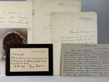 some old letters and pictures are sitting on a table