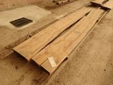 several pieces of wood sit on the ground next to a drain