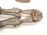 two old rusty pliers laying on a white surface